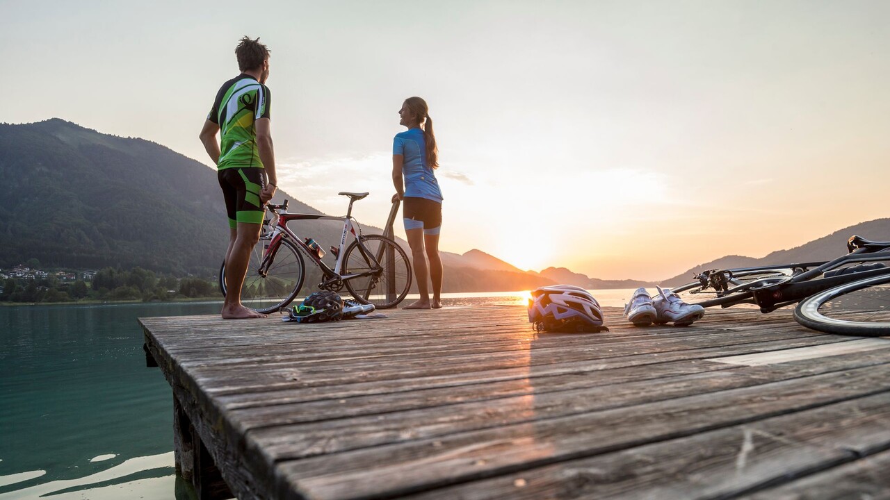 Ein Paar genießt den Sonnenuntergang während einer Rennrad-Route zwischen Gaisberg und Heuberg.